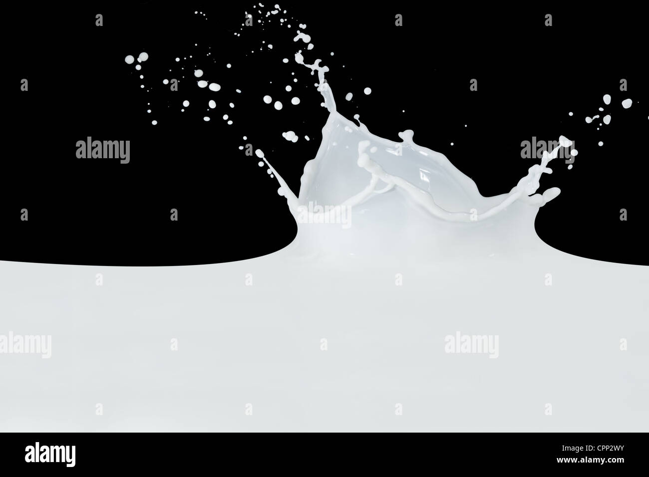 splashing milk isolated on black background Stock Photo - Alamy