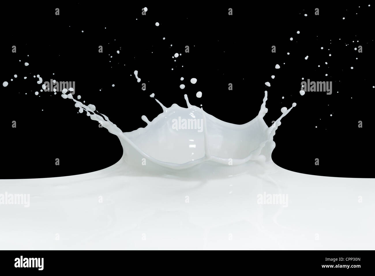 splashing milk isolated on black background Stock Photo - Alamy