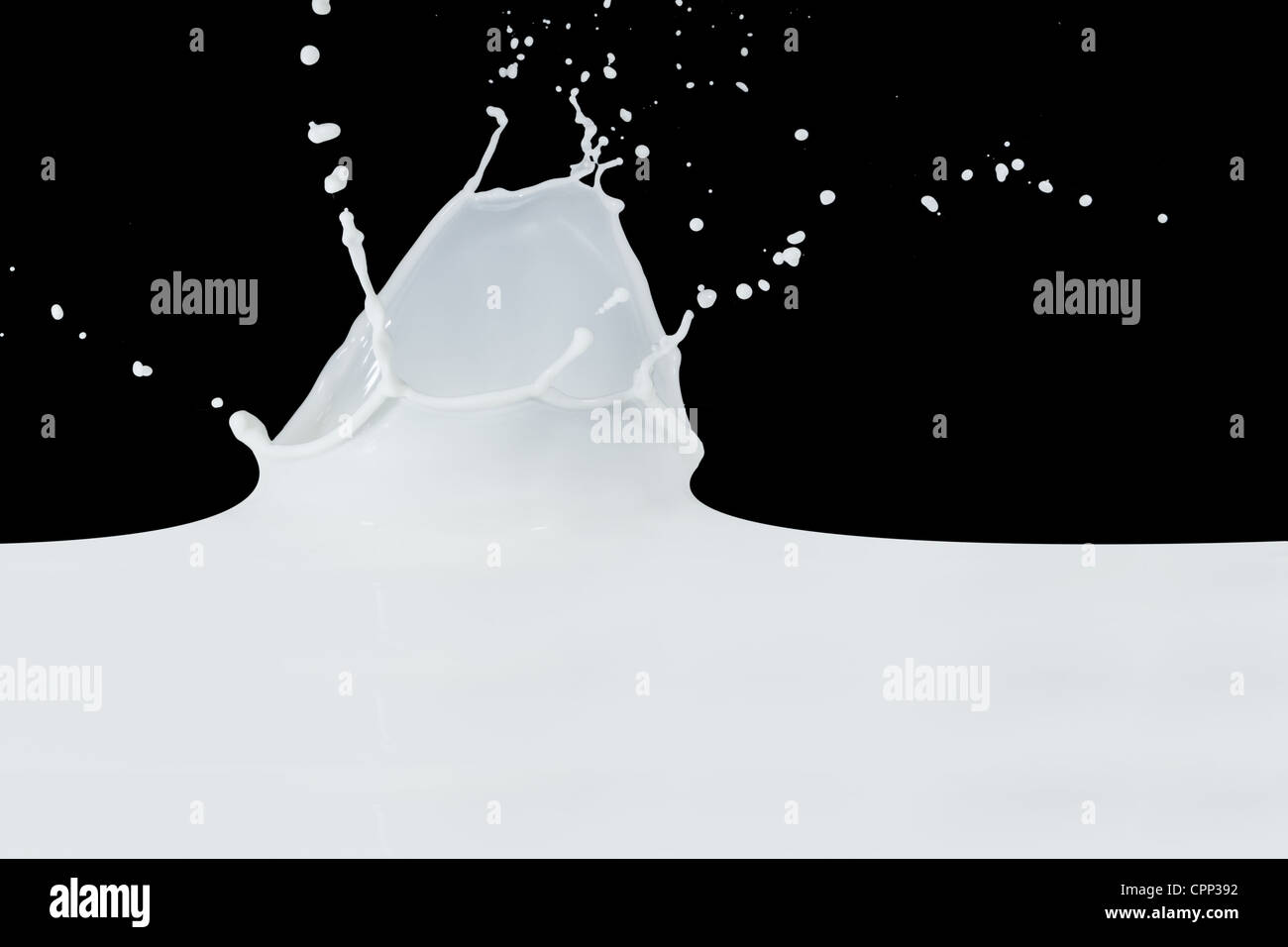 splashing milk isolated on black background Stock Photo - Alamy