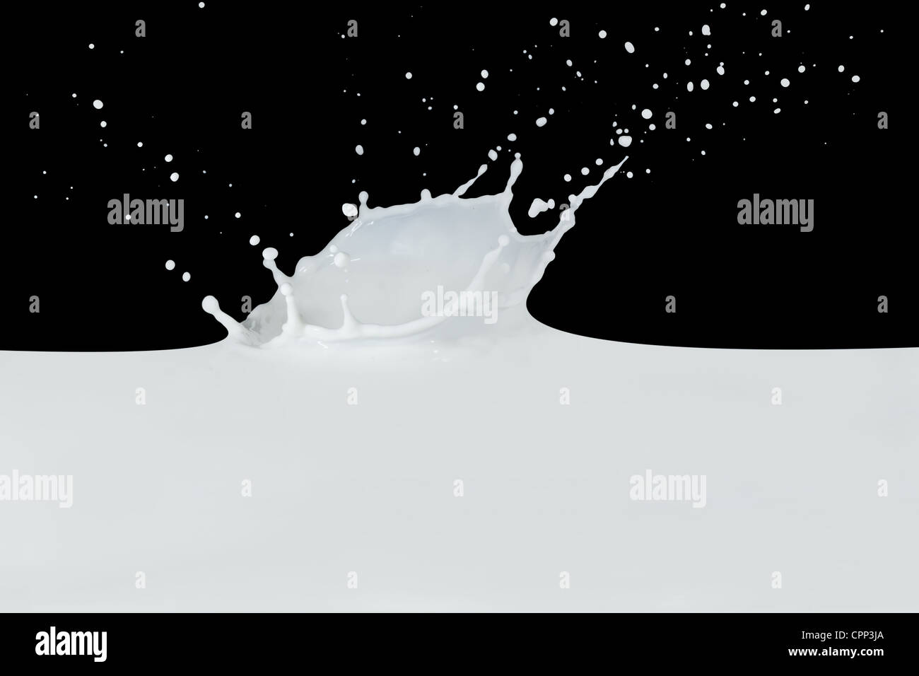 splashing milk isolated on black background Stock Photo - Alamy