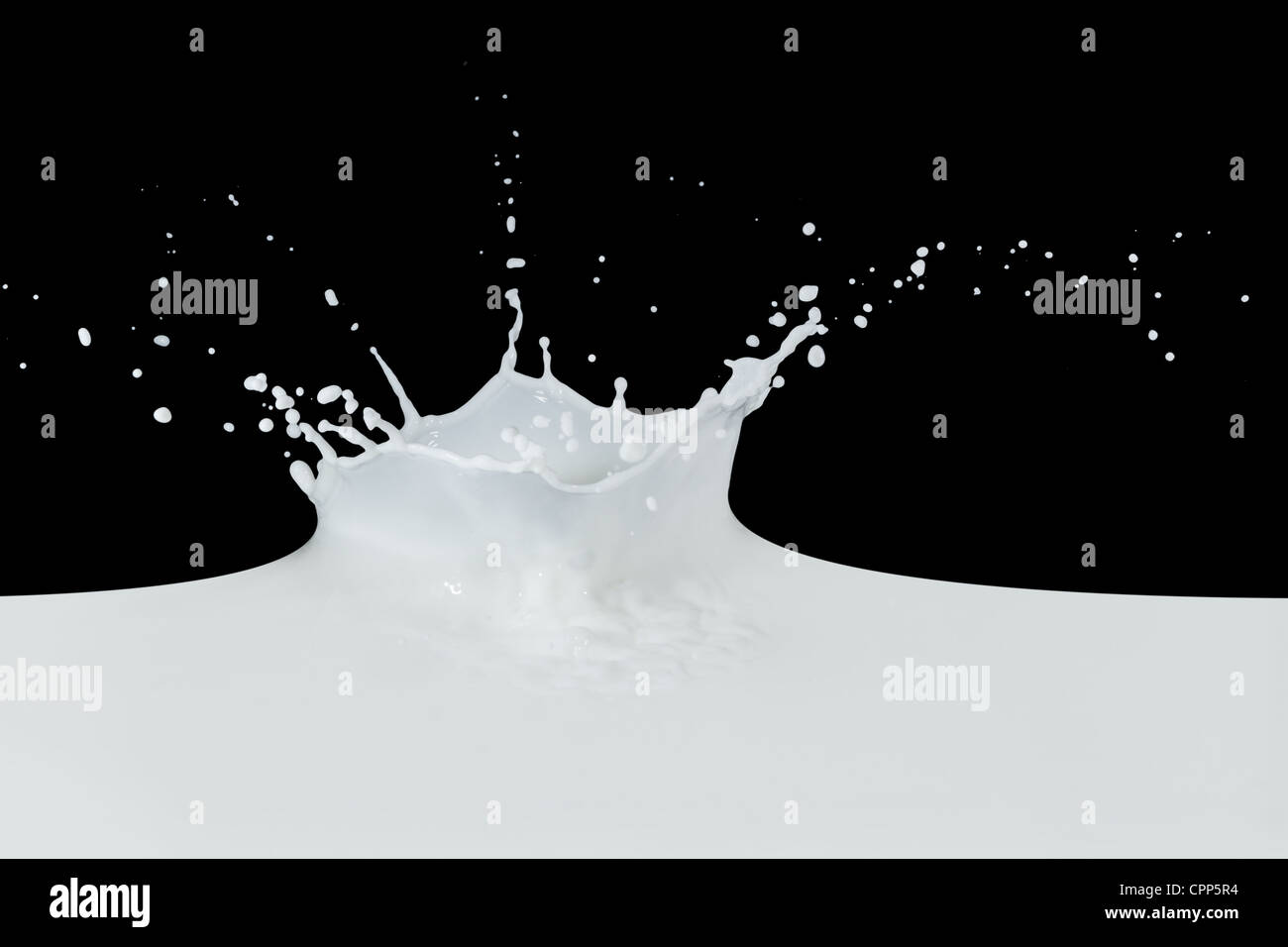 splashing milk isolated on black background Stock Photo - Alamy