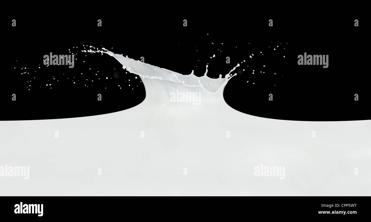splashing milk isolated on black background Stock Photo - Alamy