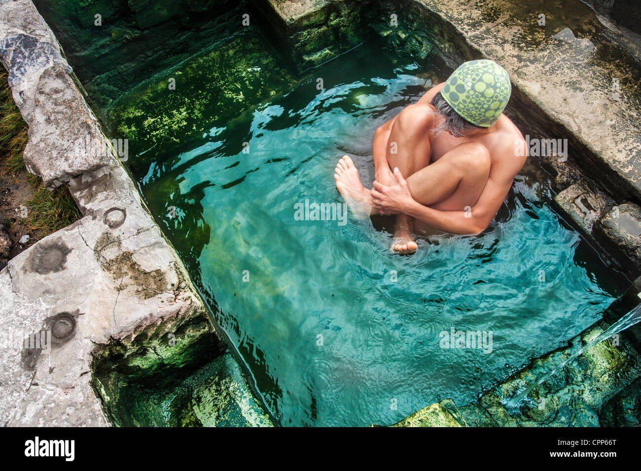 Naturally Soaking Woman soaking in a rustic, natural hot pool Stock Photo - Alamy