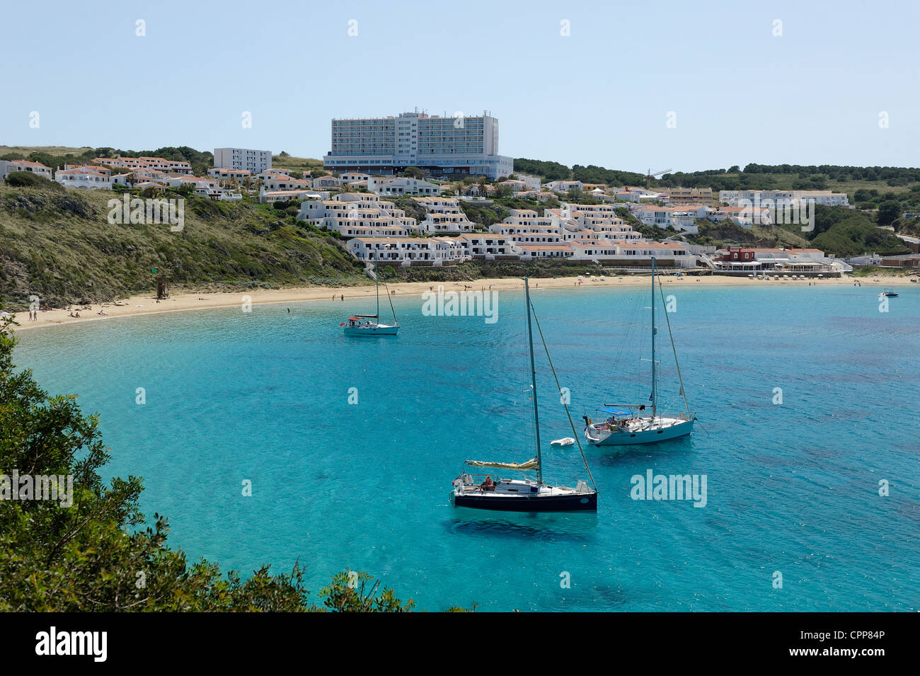 the clear blue sea of arenal d'en castell with the fiesta castell playa ...