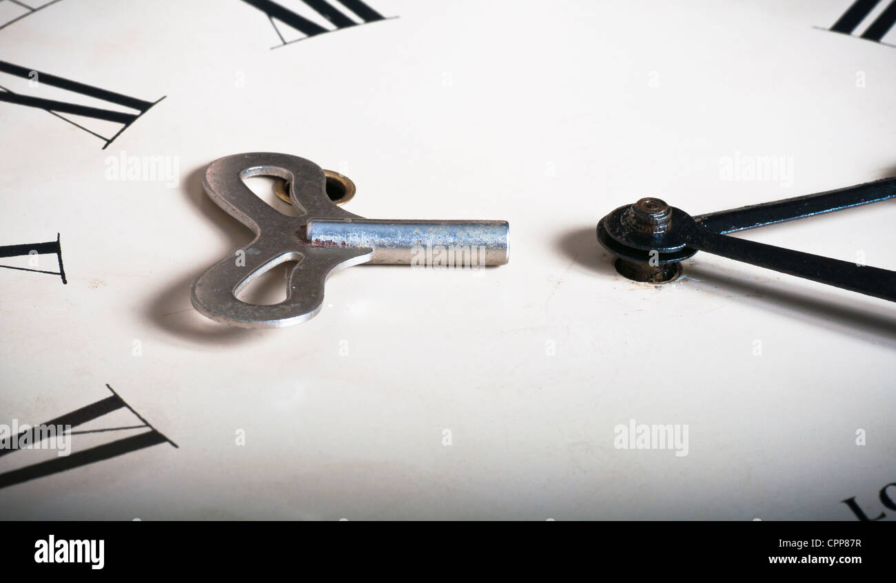Wind up clock and key Stock Photo Alamy