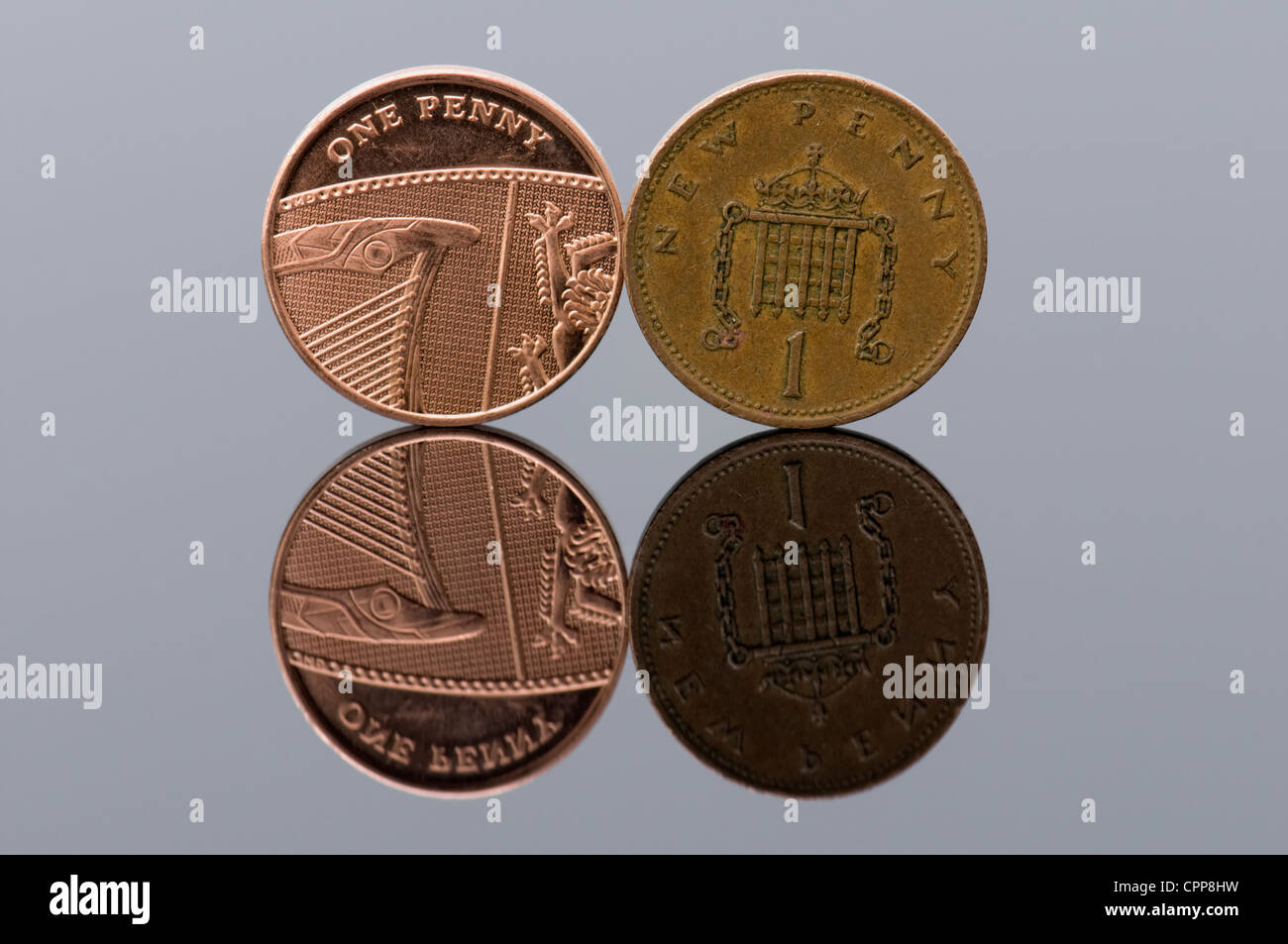 One new penny piece with the old style penny with reflection, concept every penny counts Stock Photo