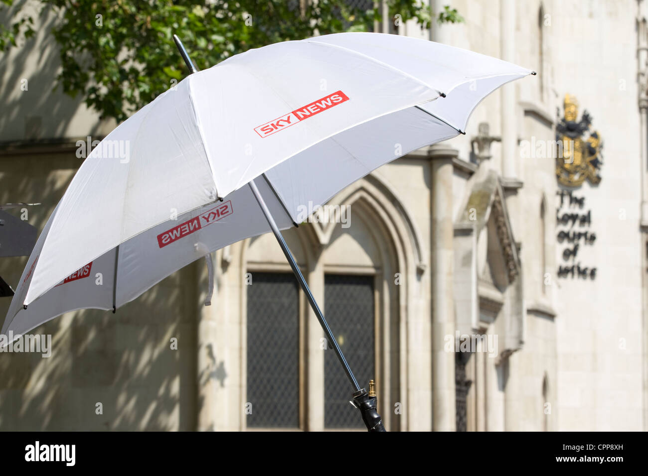 SKY News umbrella outside the front of The Royal Courts of Justice, High Court, London, England, UK. Stock Photo