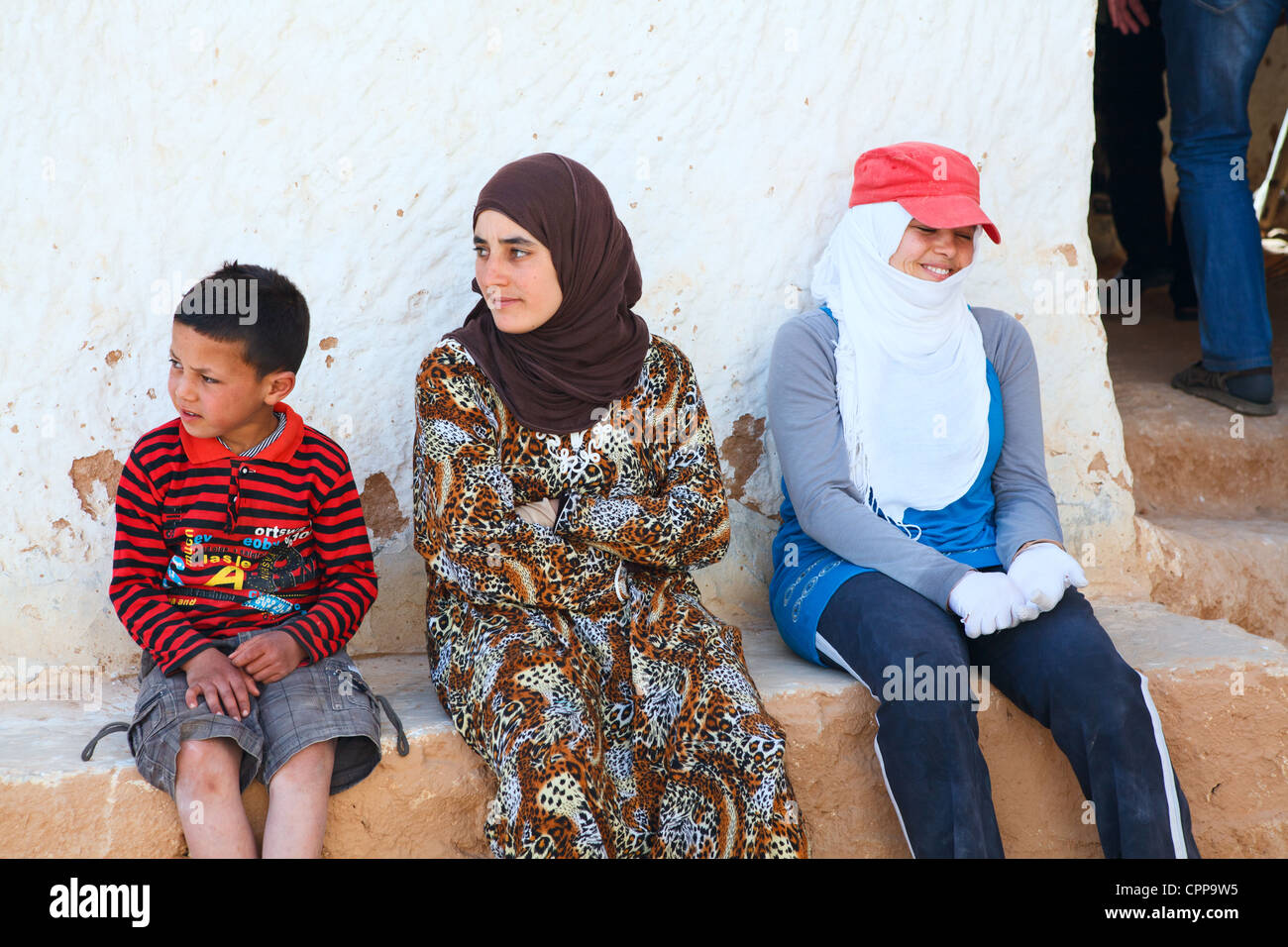 Tunisians people who lived in mountain caves - troglodytes family, Matmata, Tunisia, Africa. Underground living people Stock Photo