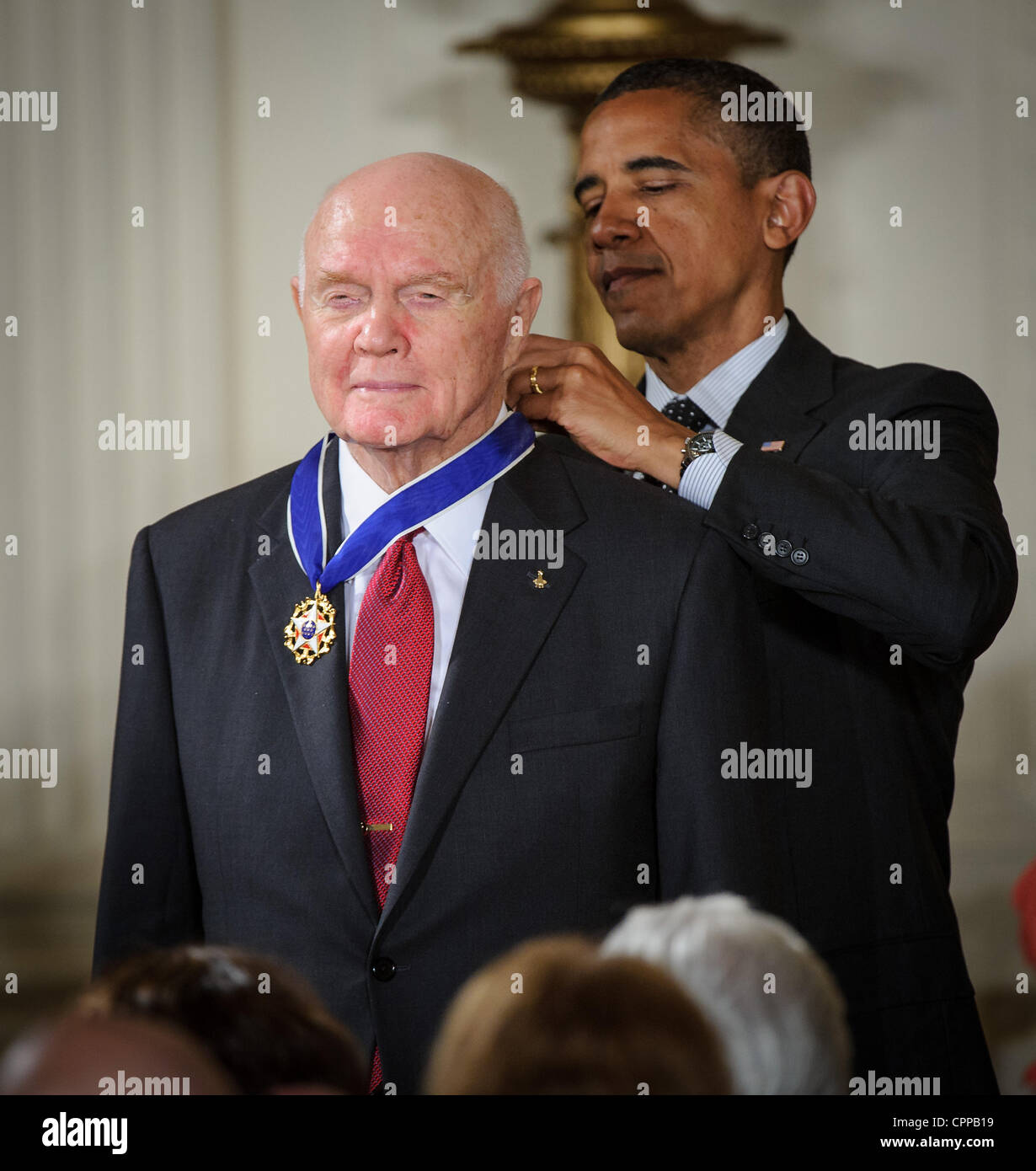 US President Barack Obama presents former United States Marine Corps pilot, astronaut, and United States Senator John Glenn with a Medal of Freedom during a ceremony at the White House May 29, 2012 in Washington, DC. Stock Photo