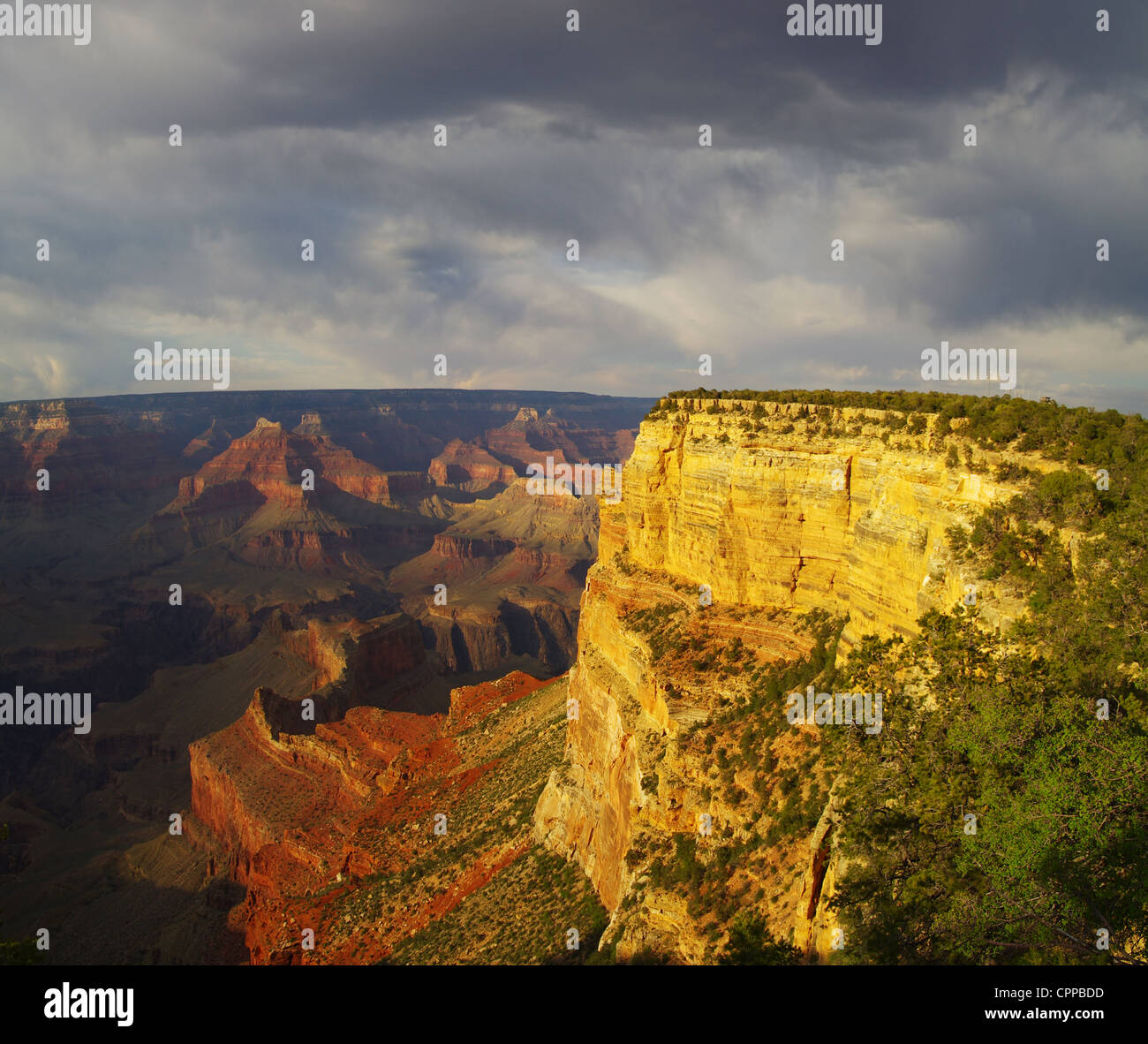 vista of the Grand Canyon past Hopi Point with dramatic evening light and stormy clouds Stock Photo