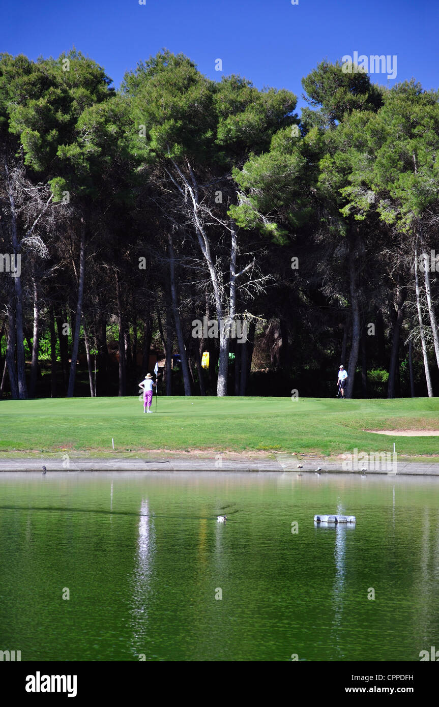 Green across lake on 8th hole at Golf Son Parc Golf Course, Son Parc, Menorca, Balearic Islands, Spain Stock Photo