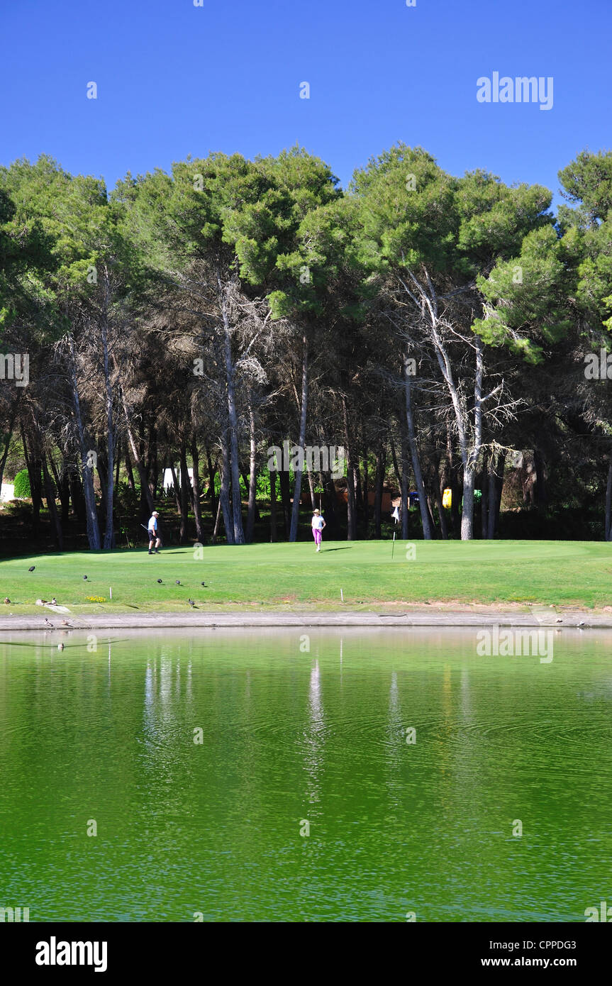 Green across lake on 8th hole at Golf Son Parc Golf Course, Son Parc, Menorca, Balearic Islands, Spain Stock Photo