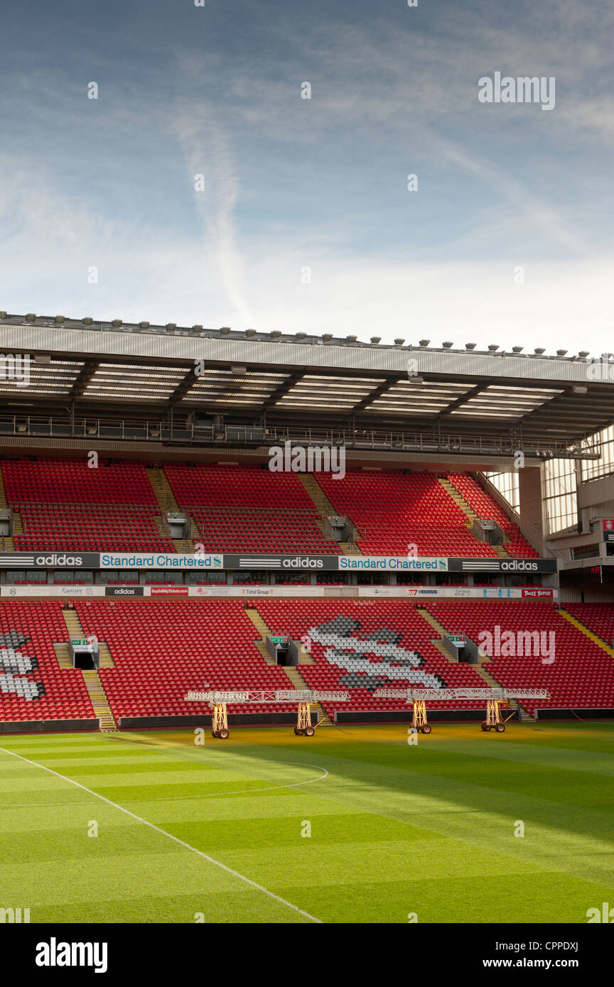 Stands and pitch at Anfield when empty. Set of lights are on pitch to encourage grass growth. Stock Photo
