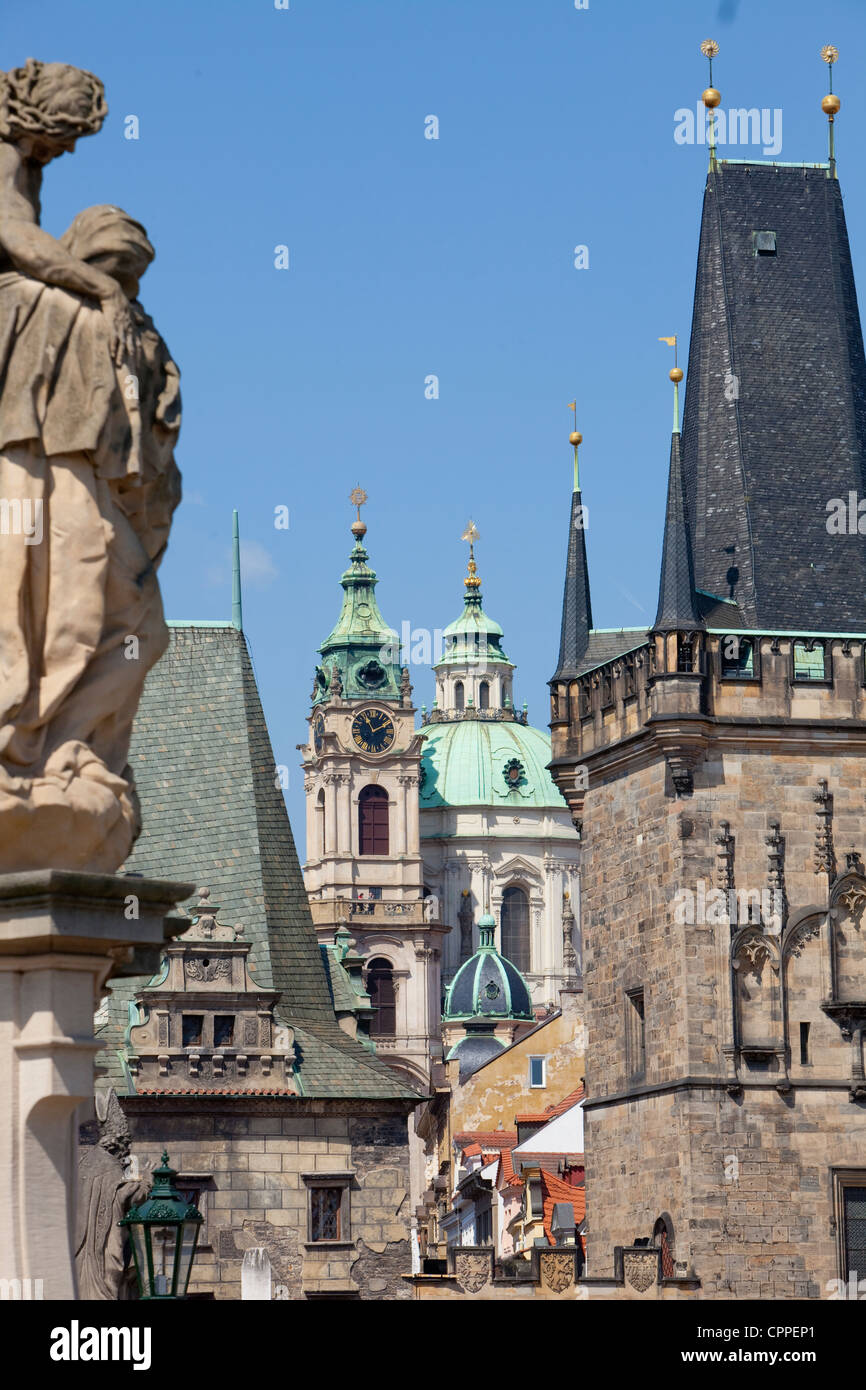 prague - different architectural styles-st. nicolas church and charles bridge tower Stock Photo