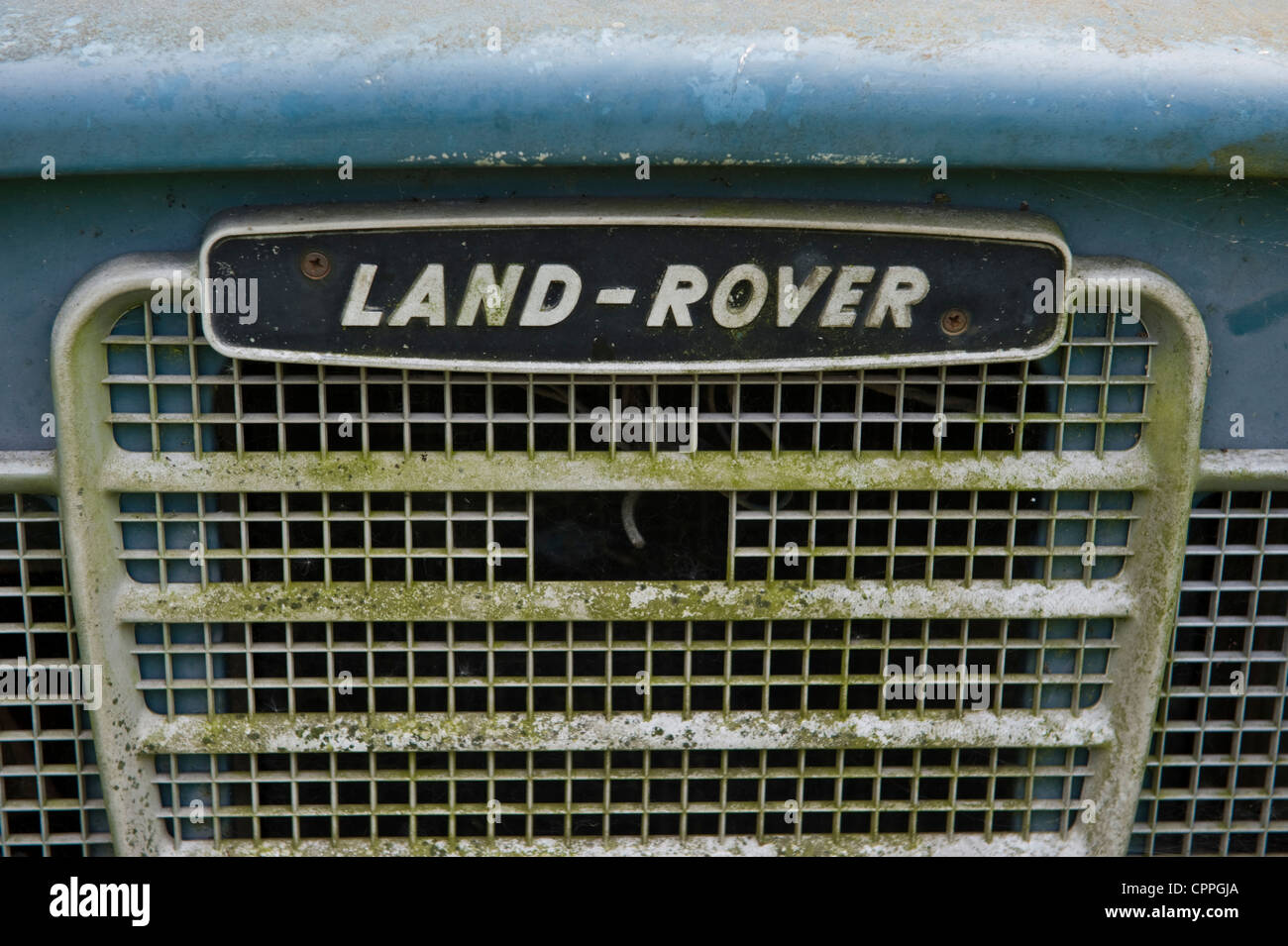 Derelict Land Rover 109 deteriorating in a field on remote farm at Llanddewi Fach Powys Mid-Wales UK Stock Photo
