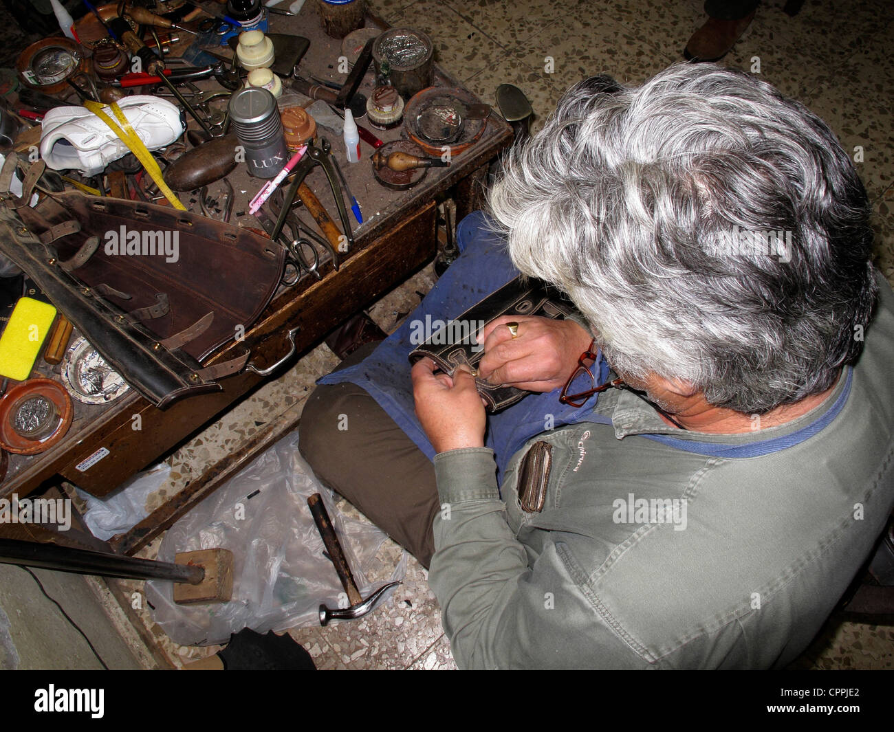 Spain Andalusia Solucar Spanish shoes maker repairing horse boots Stock Photo