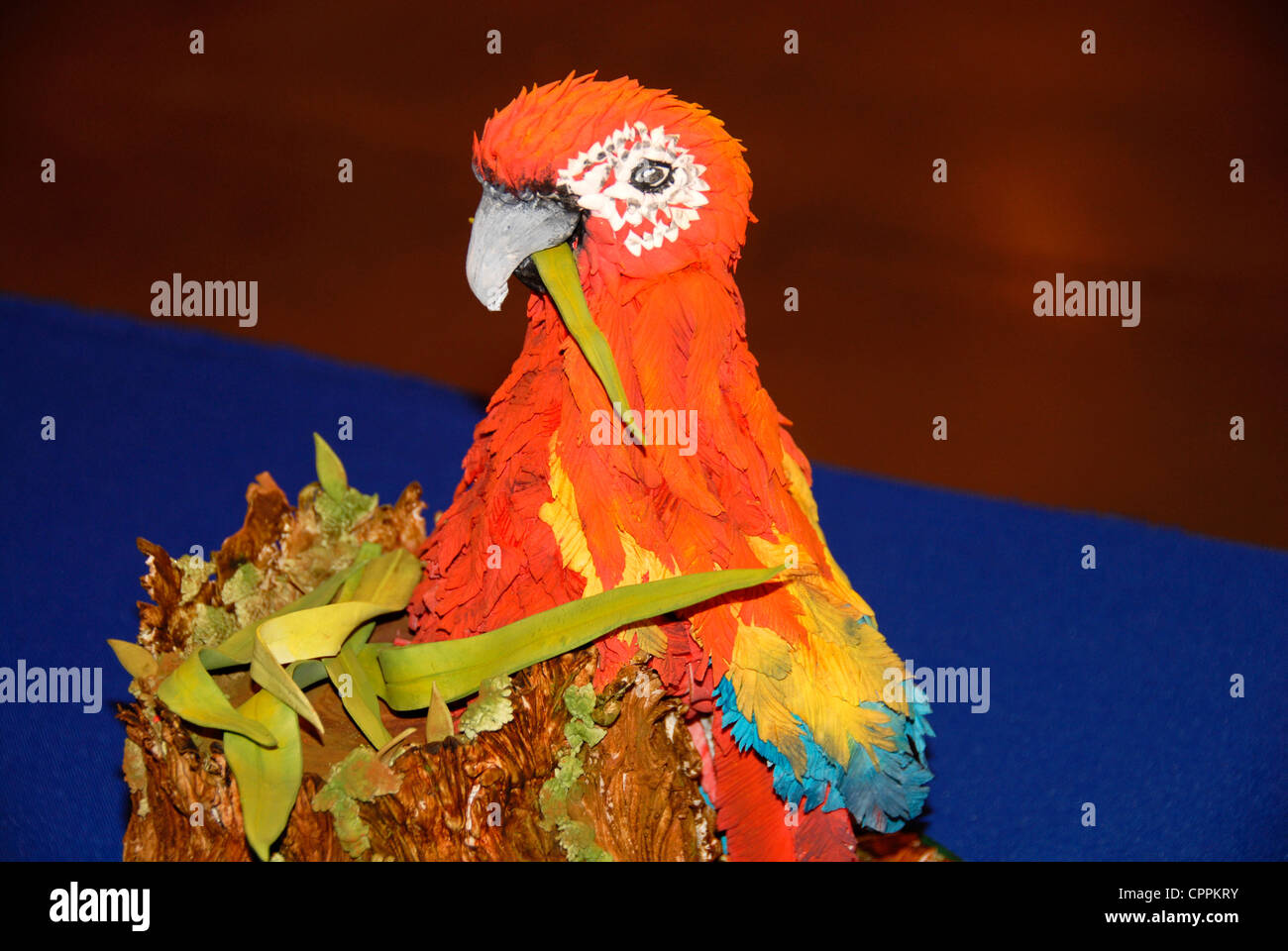 Colorful head of parrot in sugar as cake top at exhibition Stock Photo