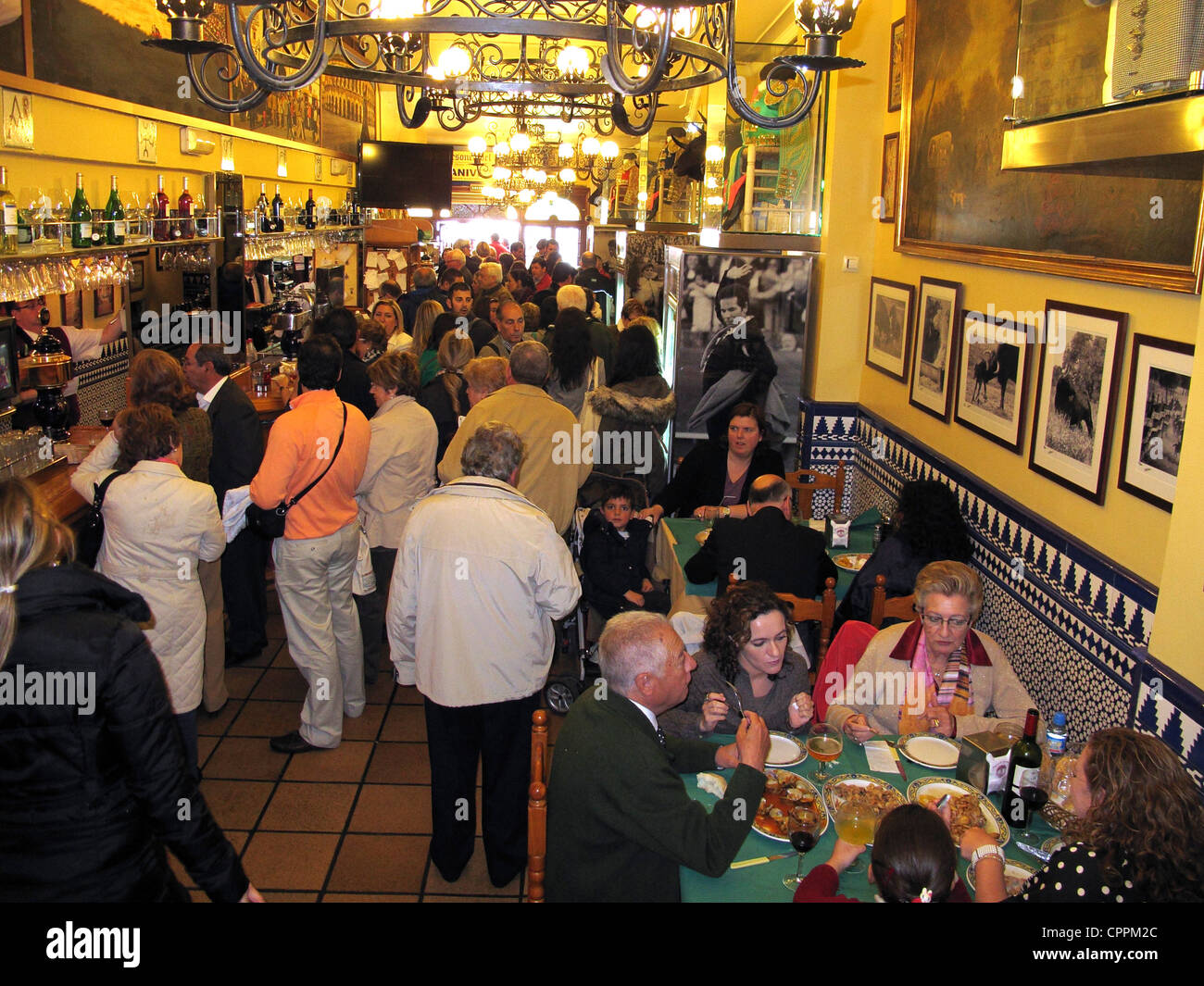 Spain Andalusia Seville people having lunch Tapas in Bodega wine cellar