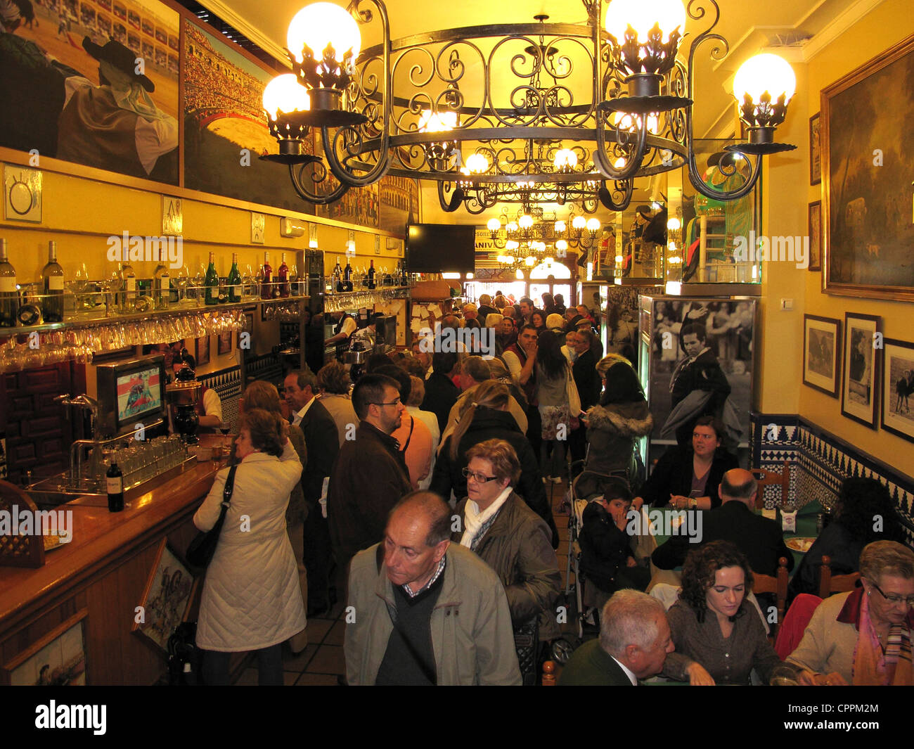 Spain Andalusia Seville people having lunch Tapas in Bodega wine cellar bar Stock Photo