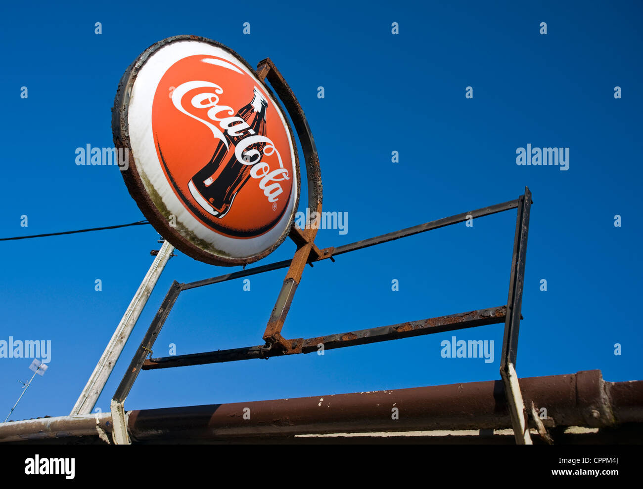 Dis-used corrugated iron building with Coca Cola sign, Killyleagh, Northern Ireland. Stock Photo