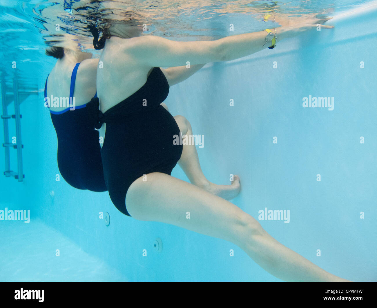 PREGNANT WO. EXERCISING IN WATER Stock Photo
