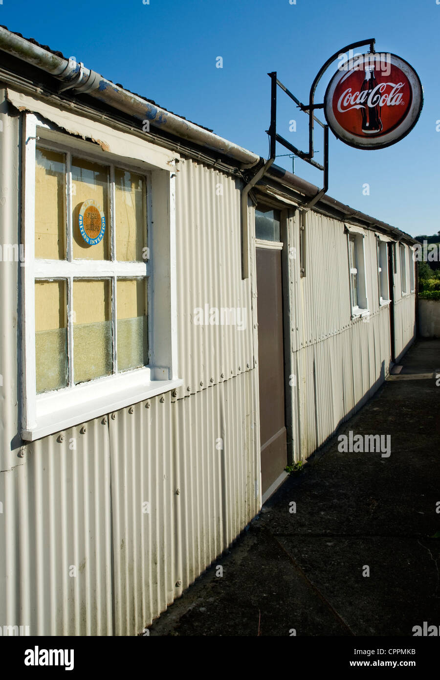 Dis-used corrugated iron building with Coca Cola sign, Killyleagh, Northern Ireland. Stock Photo