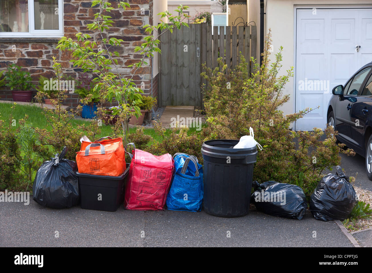 Household waste and recycling awaiting kerbside collection by Cornwall Council contractors sorted into coloured bags Stock Photo Alamy