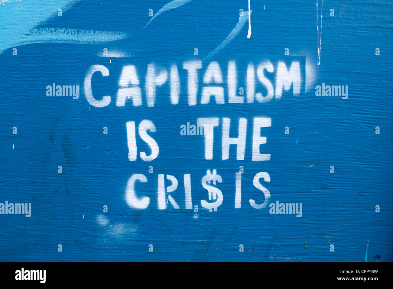 Capitalism is the Crisis sign stencilled political notice with dollar signs on a street in Montreal Quebec Canada  KATHY DEWITT Stock Photo