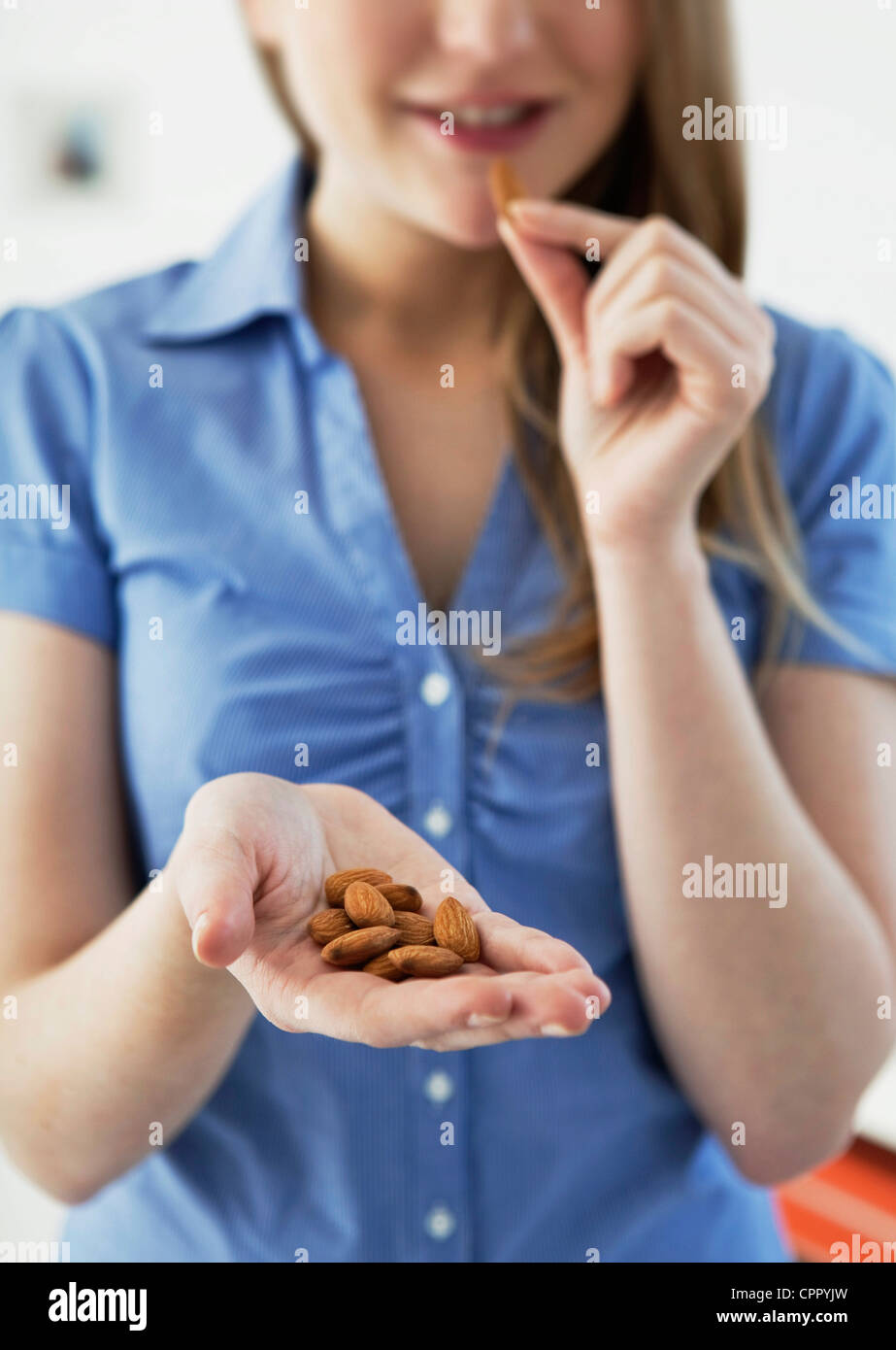 WOMAN EATING DRIED FRUIT Stock Photo Alamy