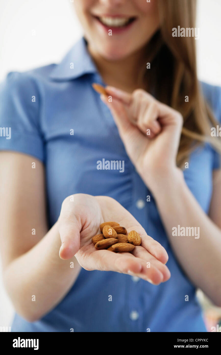 WOMAN EATING DRIED FRUIT Stock Photo Alamy
