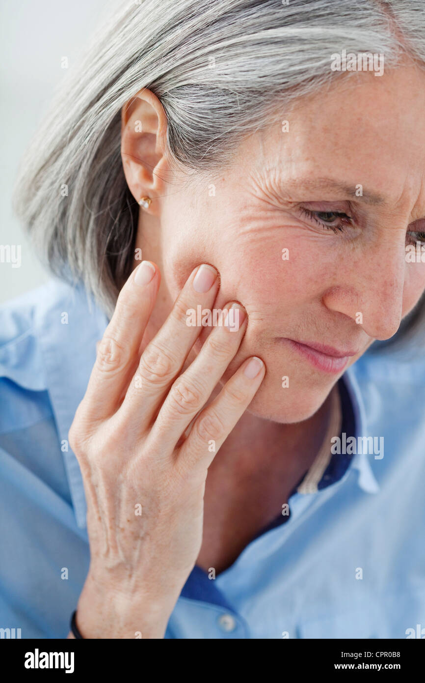 ELDERLY PERSON WITH A TOOTHACHE Stock Photo