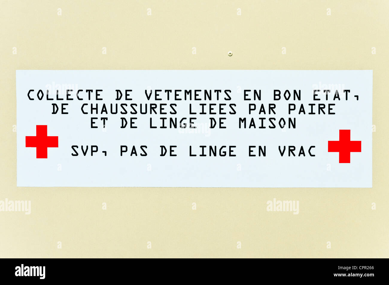 French notice on Red Cross collection bin for clothing France Stock