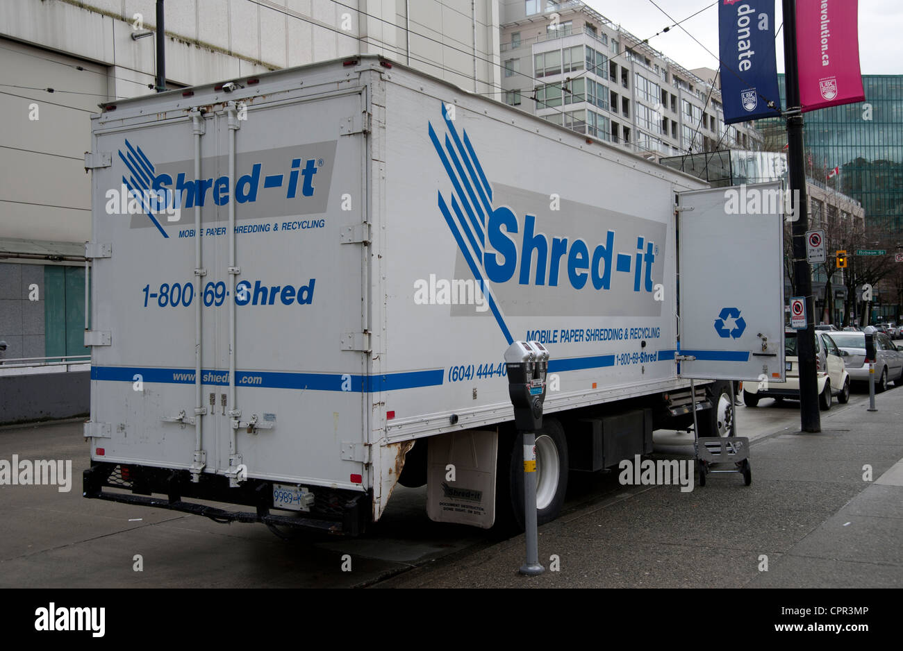 Shred-it truck at the side of the road picking up documents for shredding Stock Photo