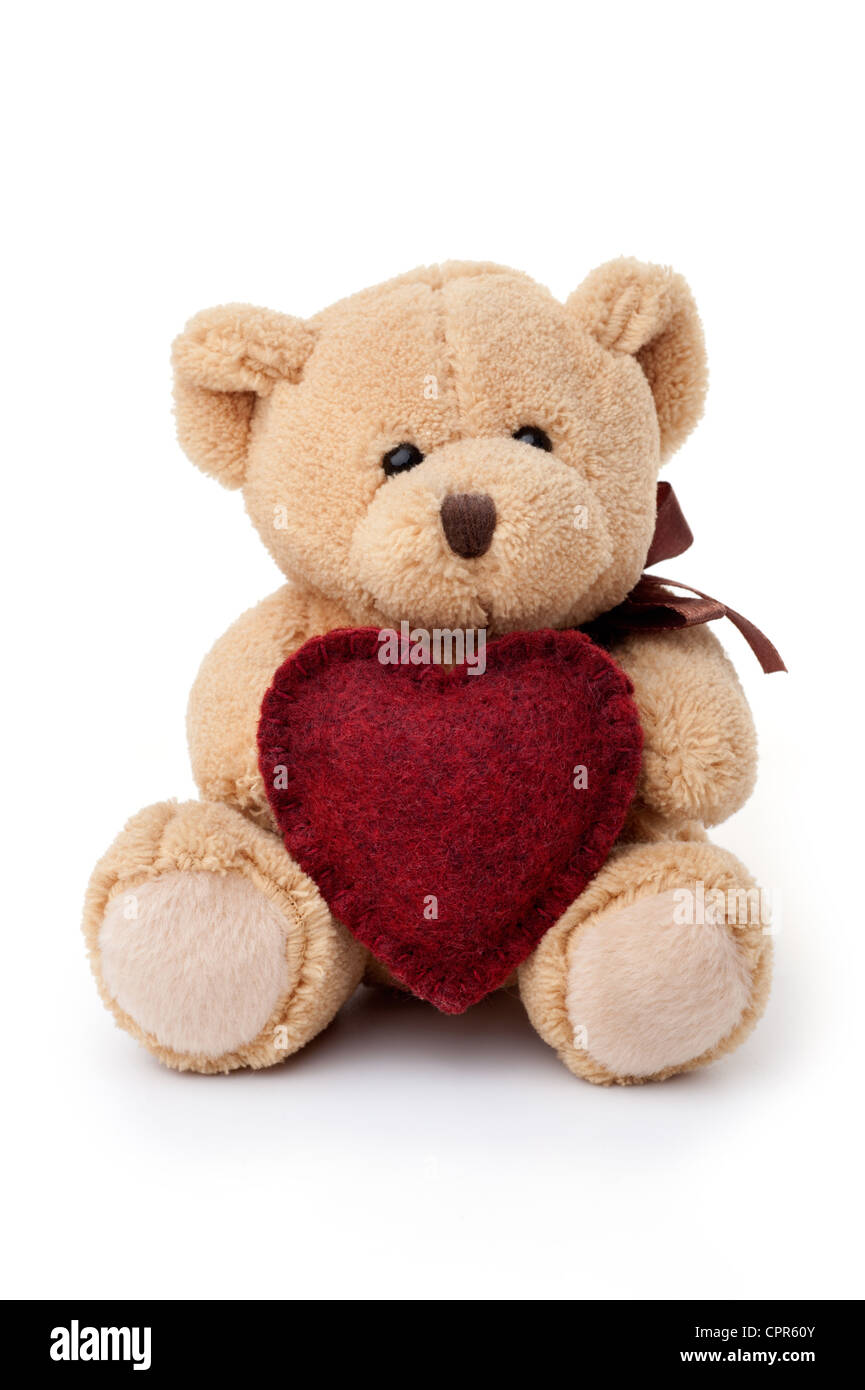 Small teddy bear holding red heart, sitting, isolated on white ...