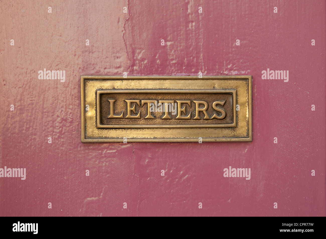 rose door and close up of a mail box with the word Letters inscribed on the metal. Stock Photo