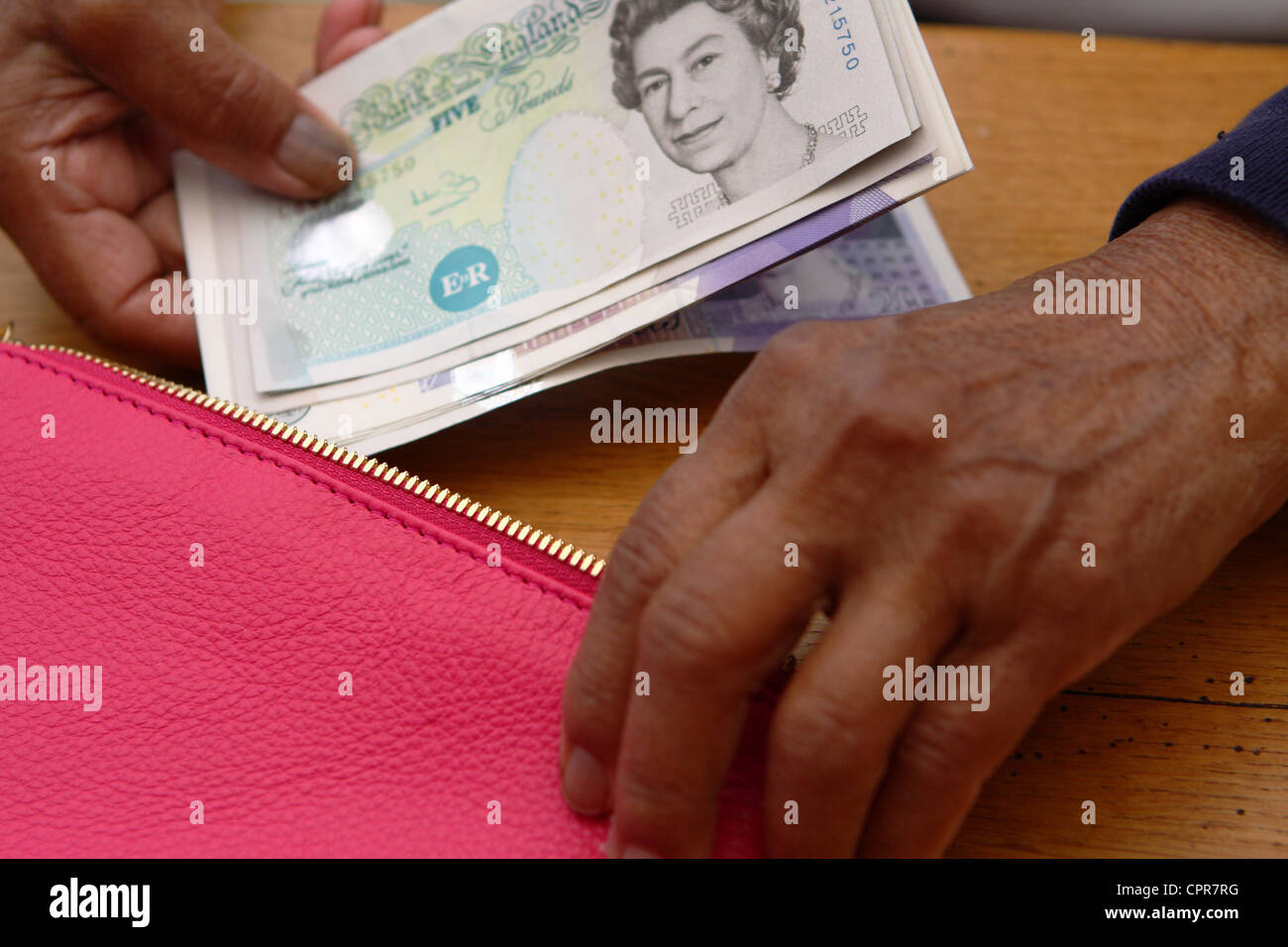 Sterling notes in hand hi-res stock photography and images - Alamy