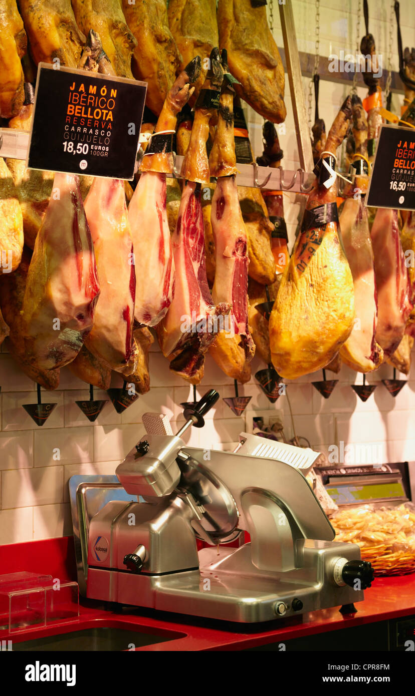 Cured Iberian ham hanging in a butcher's shop. Mercado de San miguel. Madrid. Spain Stock Photo