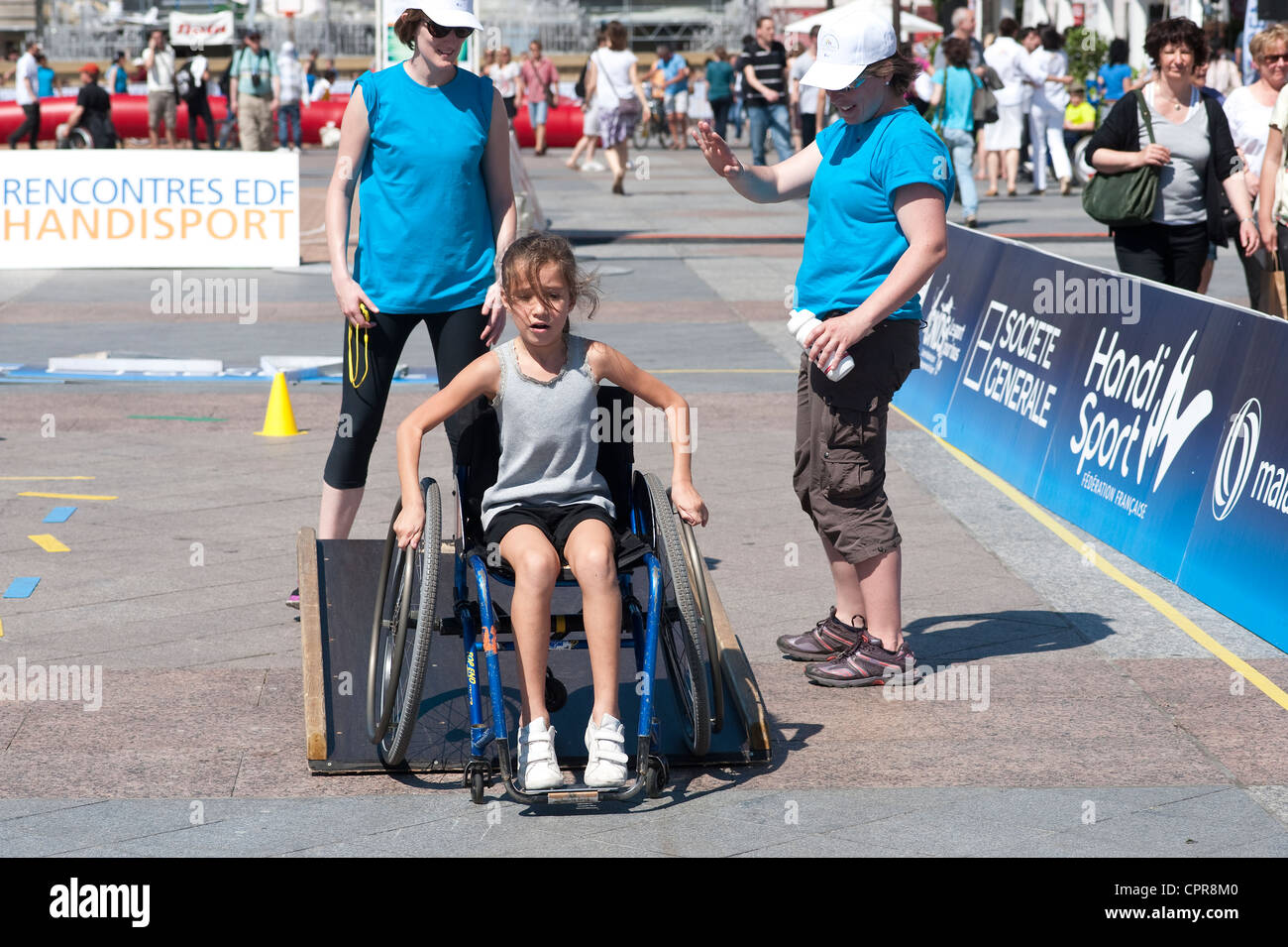 Paris, France - A young girl learning how to use a wheelchair. Stock Photo