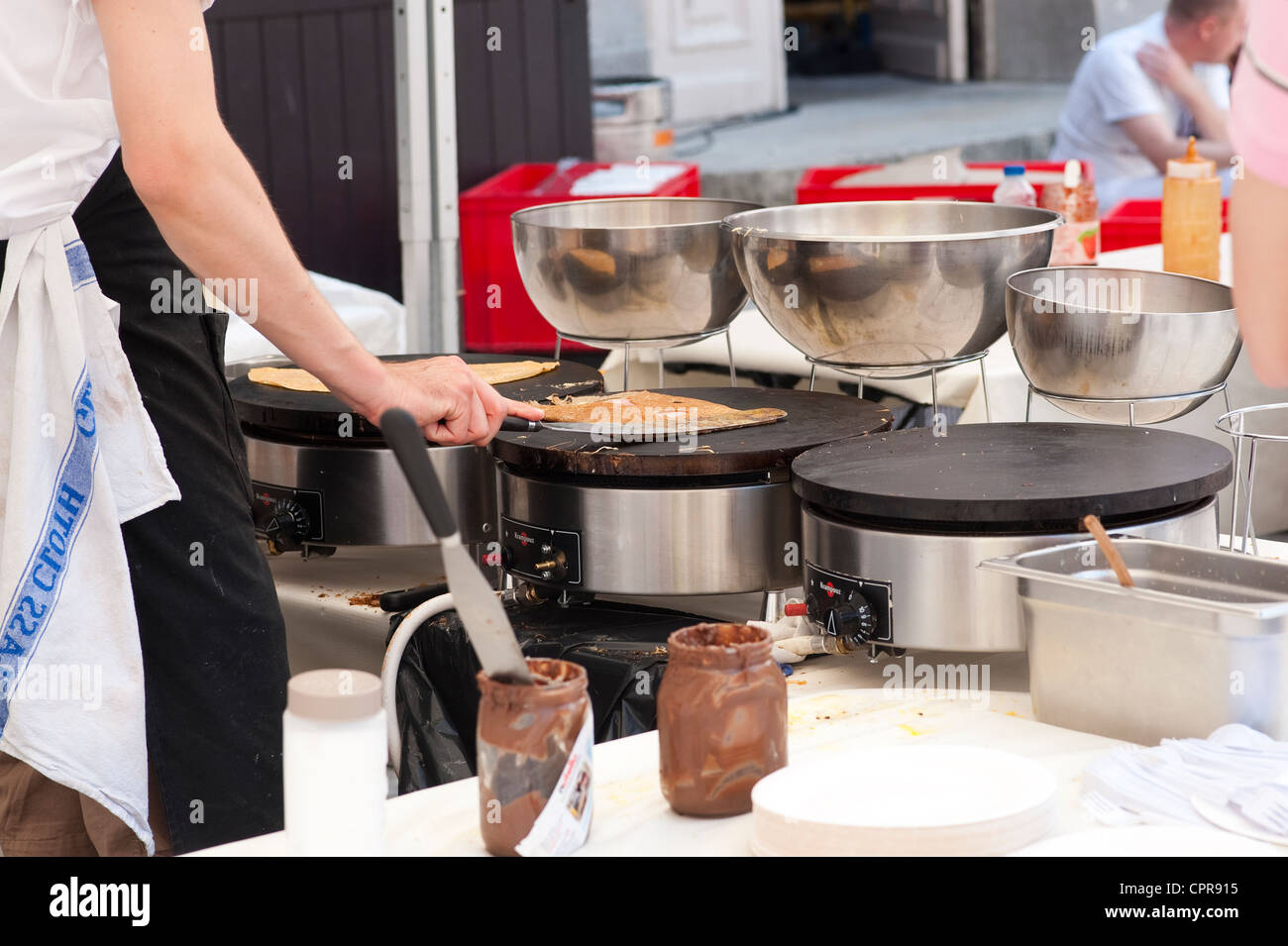 Paris, France - French man making crepes Stock Photo