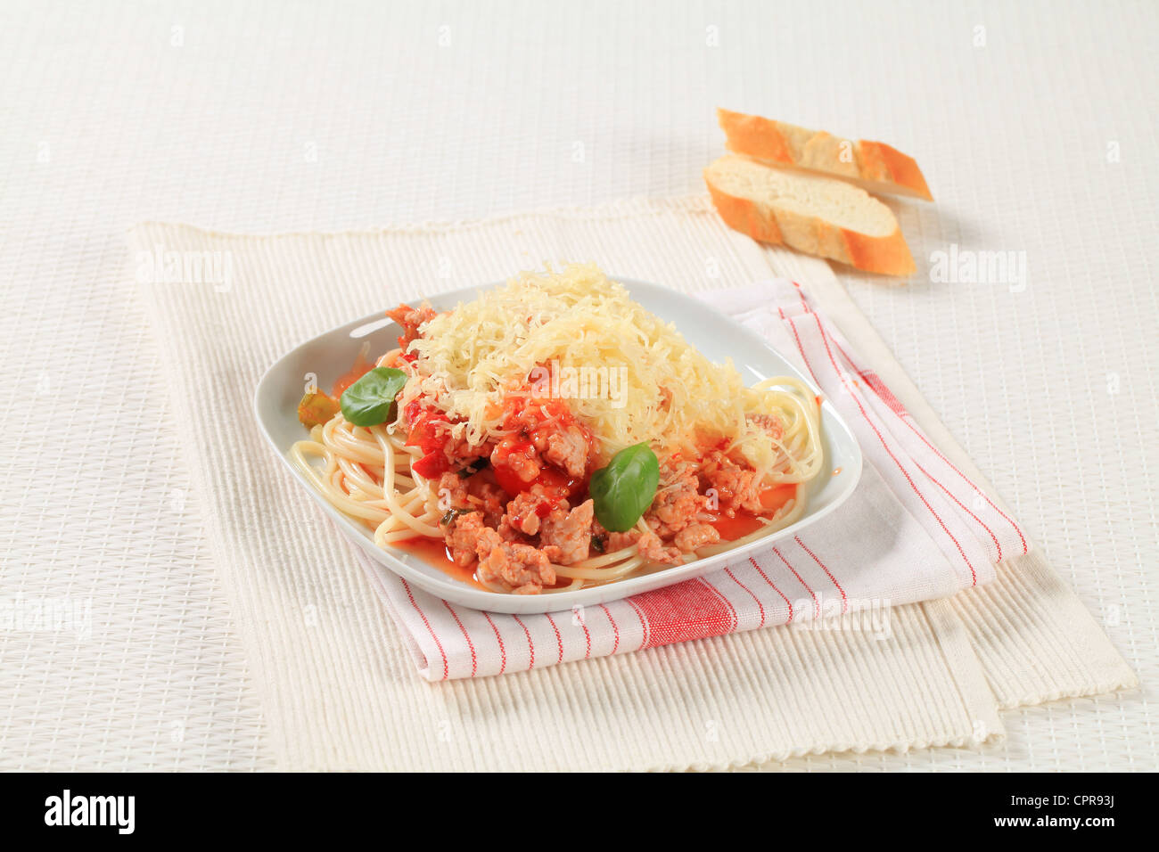 Spaghetti with minced meat and tomato sprinkled with cheese Stock Photo