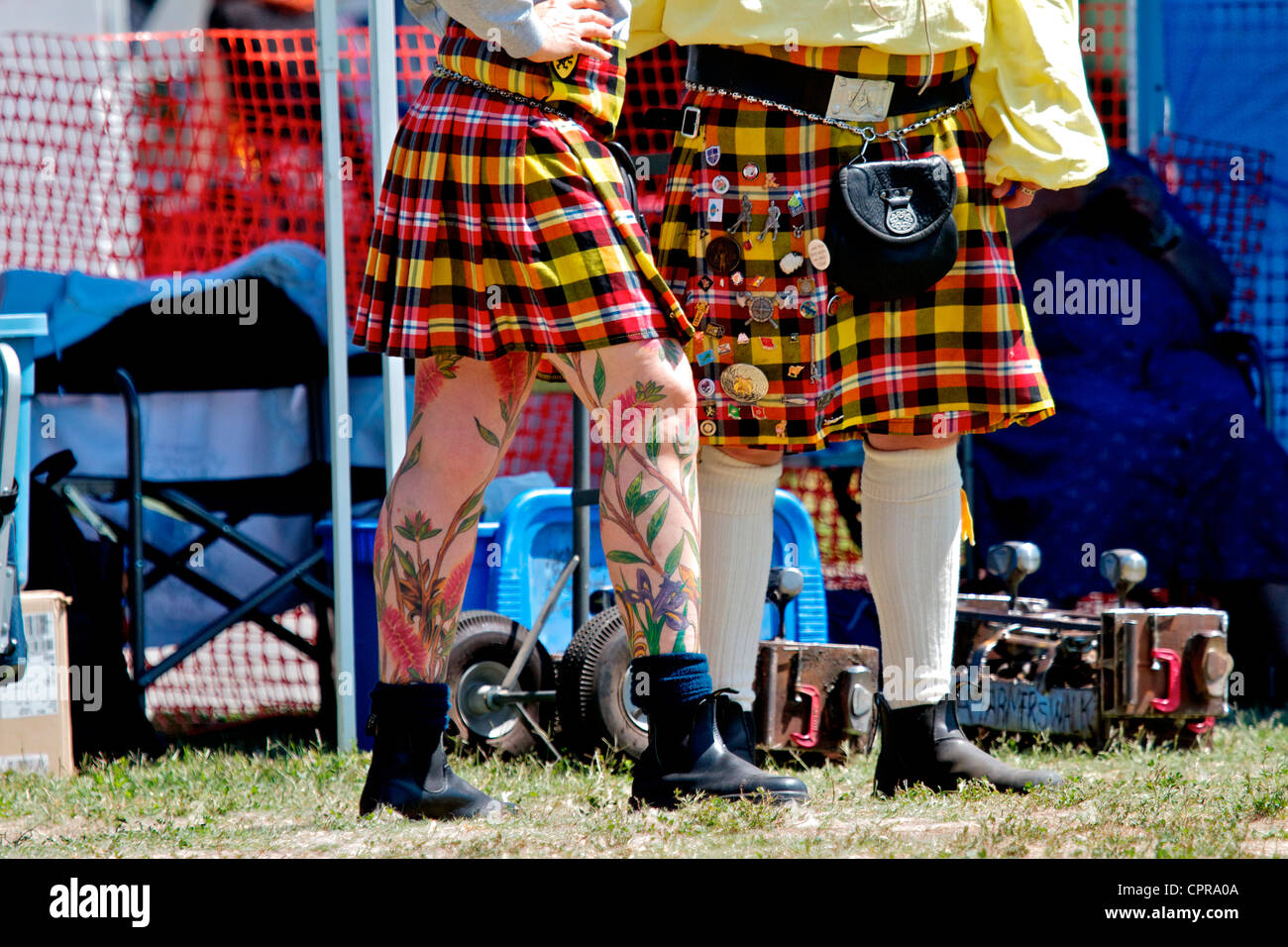man and woman in colorful red and yellow kilts at the Scottish Festival