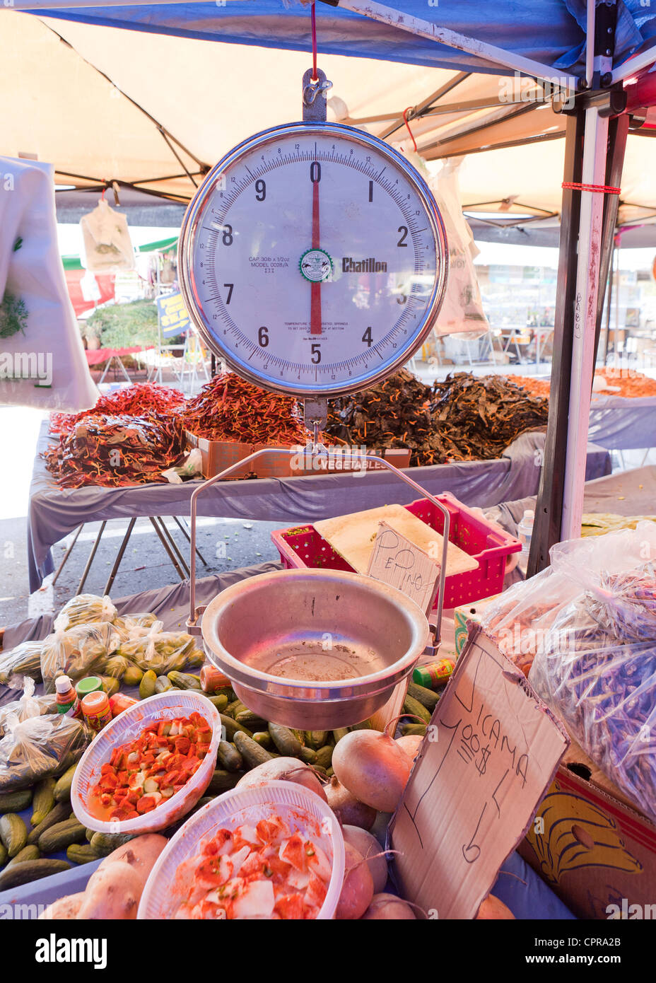 An analog dial scale at an outdoor market Stock Photo
