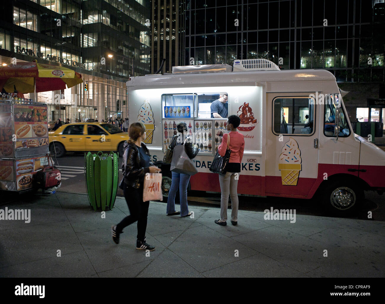 An ice cream truck does business late at night in New York City Stock