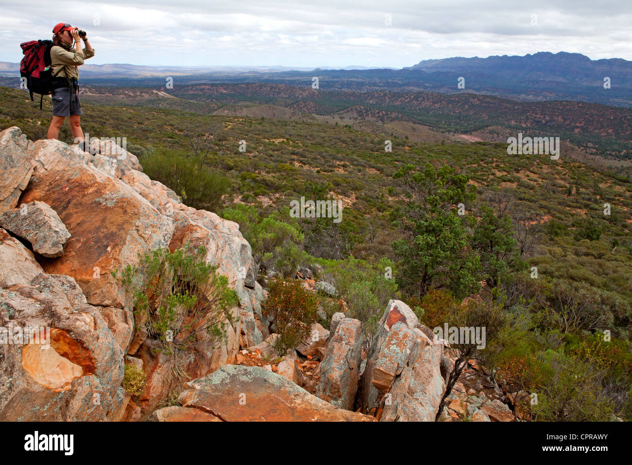 Bushwalker at Bridle Gap (Wilpena Pound) in South Australia's Flinders Ranges, looking out to the Elder Range Stock Photo