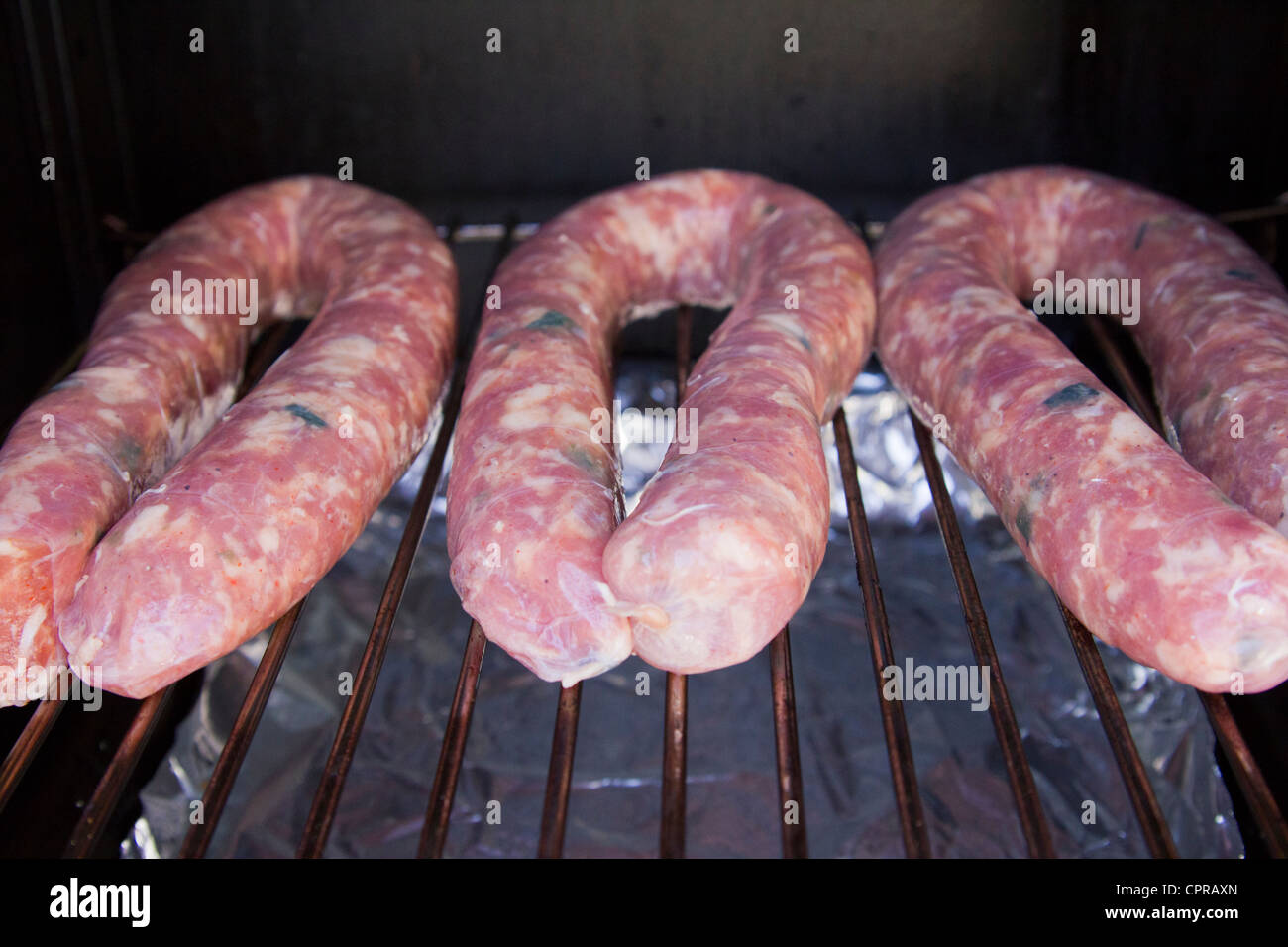 Sausage links on smoker Stock Photo