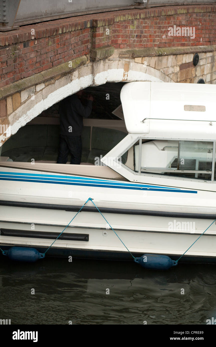 Broads cruiser stuck under Wroxham bridge, Norfolk Broads, UK Stock Photo