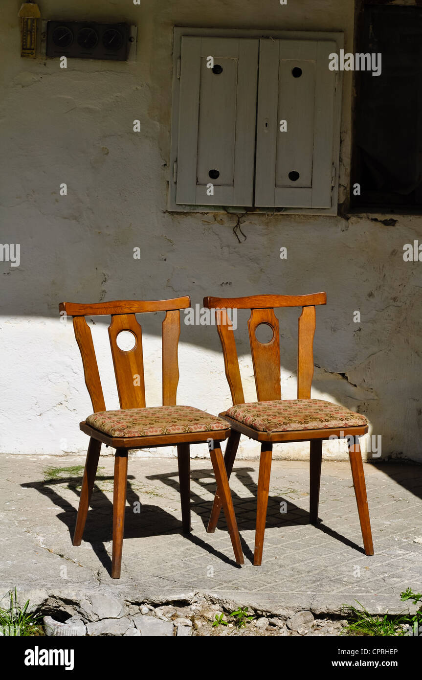 two old wooden chairs are standing close on an old porch Stock Photo ...