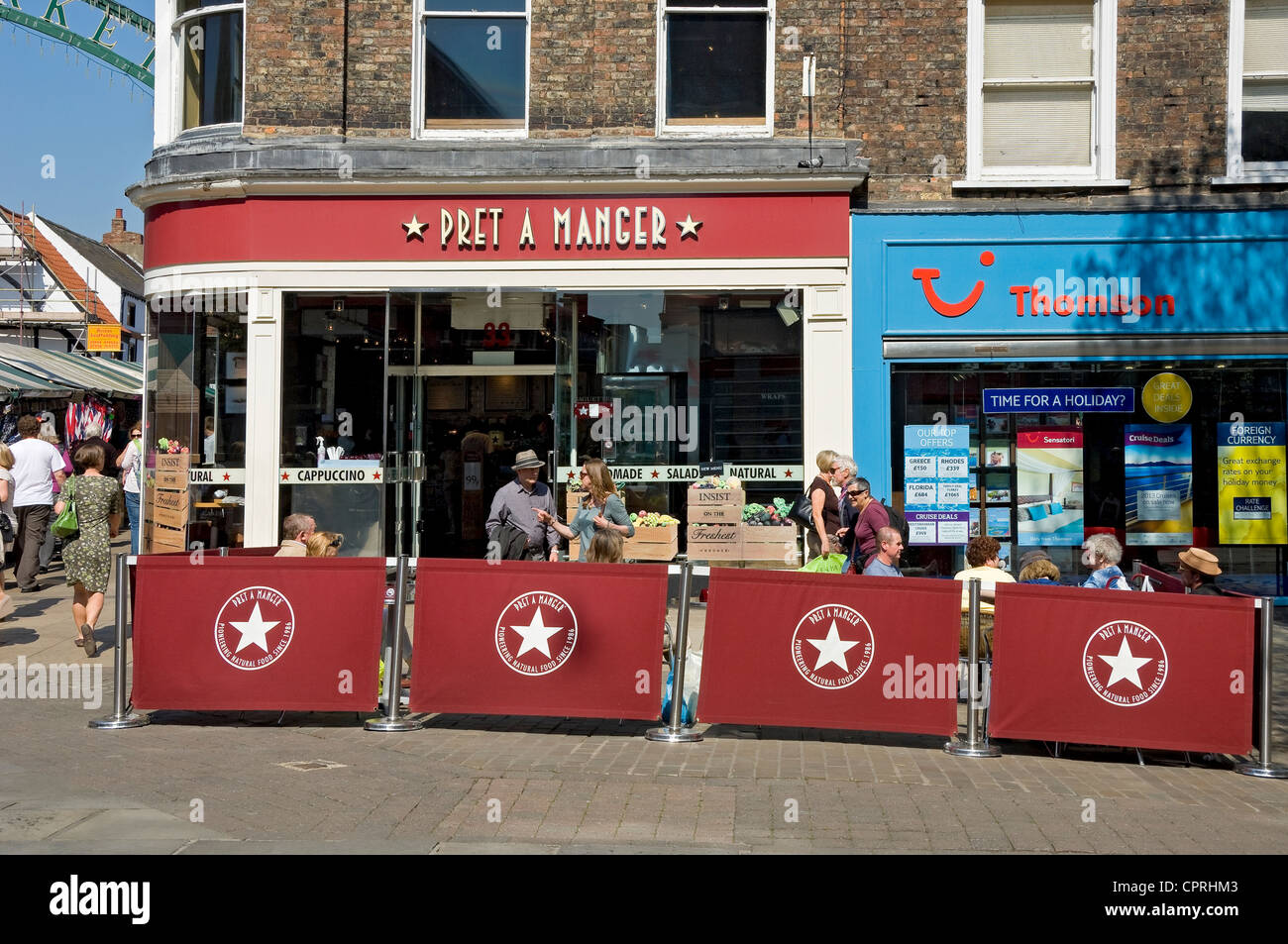 People tourists visitors outside Pret a Manger exterior seating in spring York City Town Centre North Yorkshire England UK United Kingdom Britain Stock Photo