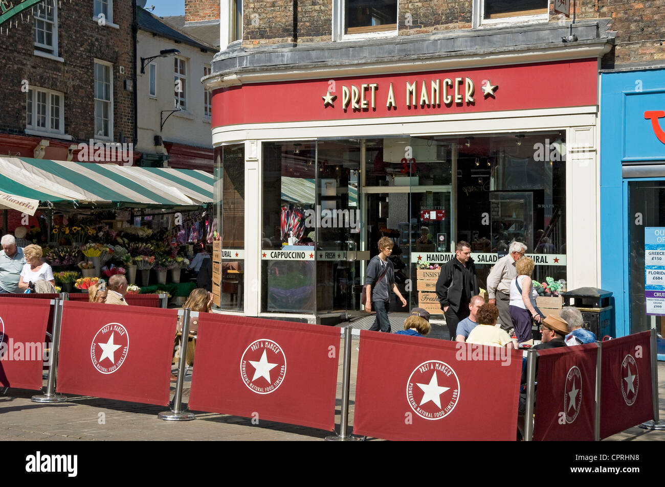 People tourists visitors sitting outside Pret a Manger in spring York City Town Centre North Yorkshire England UK United Kingdom GB Great Britain Stock Photo
