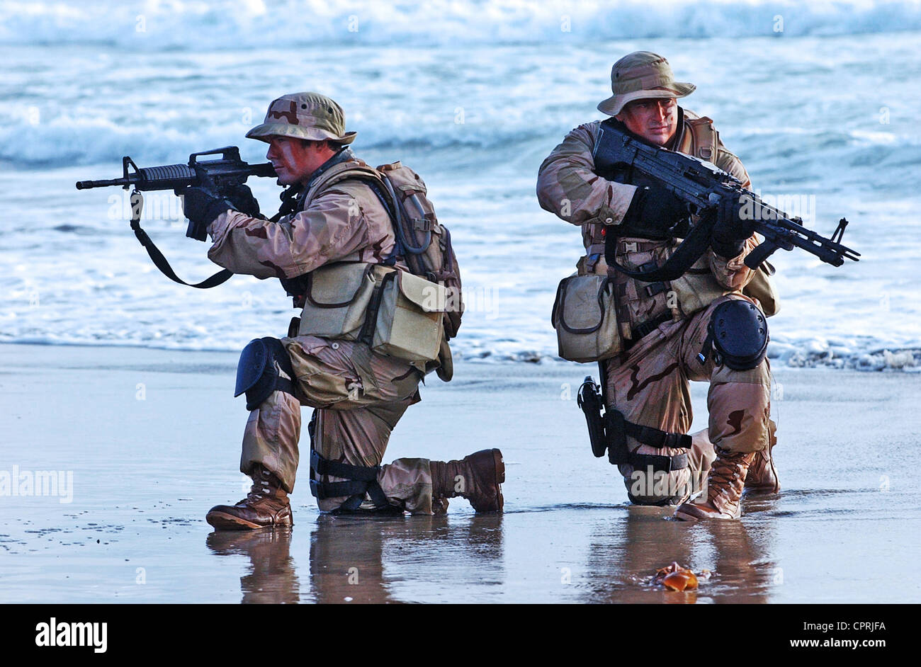 US Navy SEALs practice beach landings during combat training Stock Photo